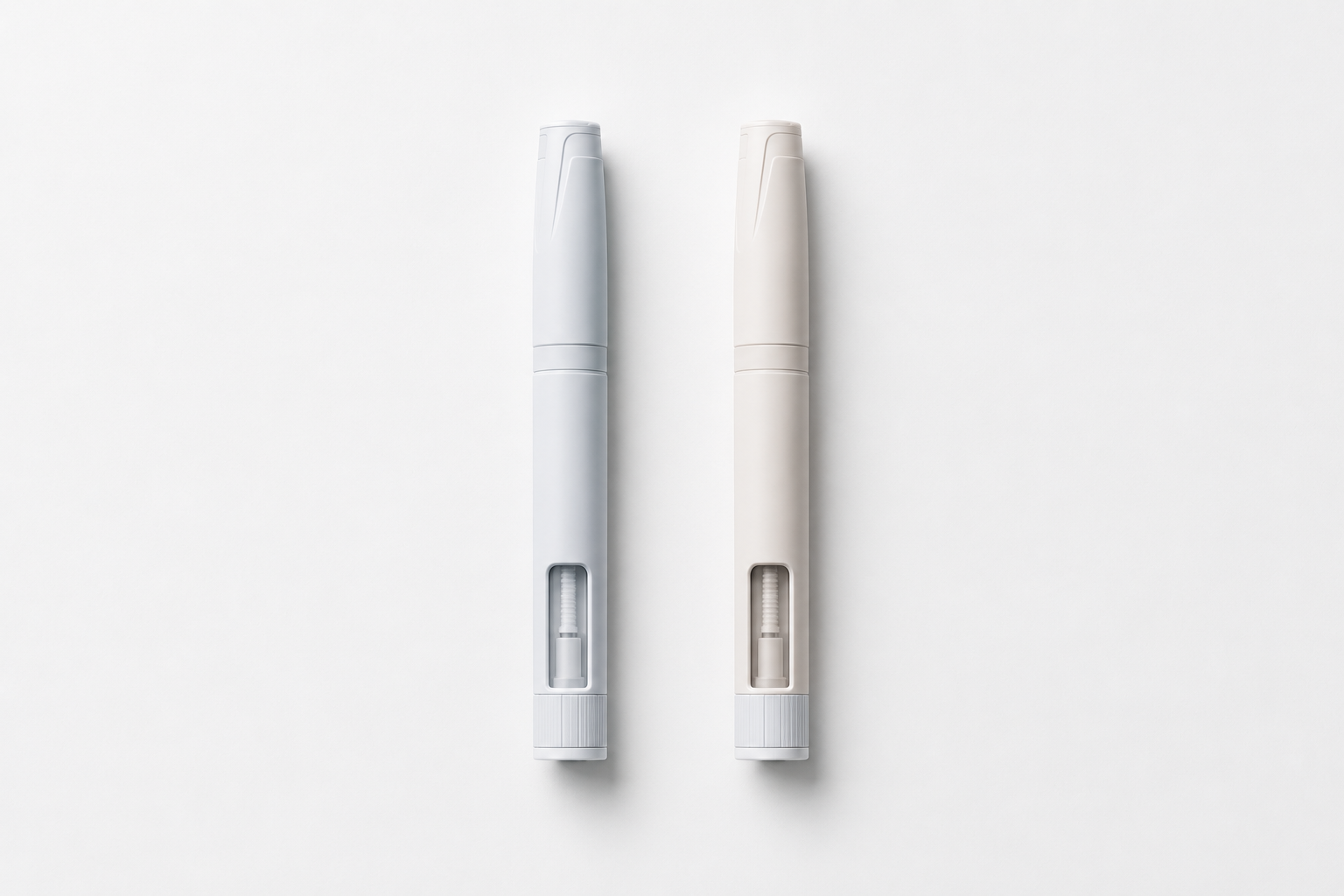 Two weekly injection pens side by side on white surface representing semaglutide and tirzepatide comparison